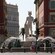 A fountain with a giant statue of the Greek god Apollo and 5 sculptures representing planets